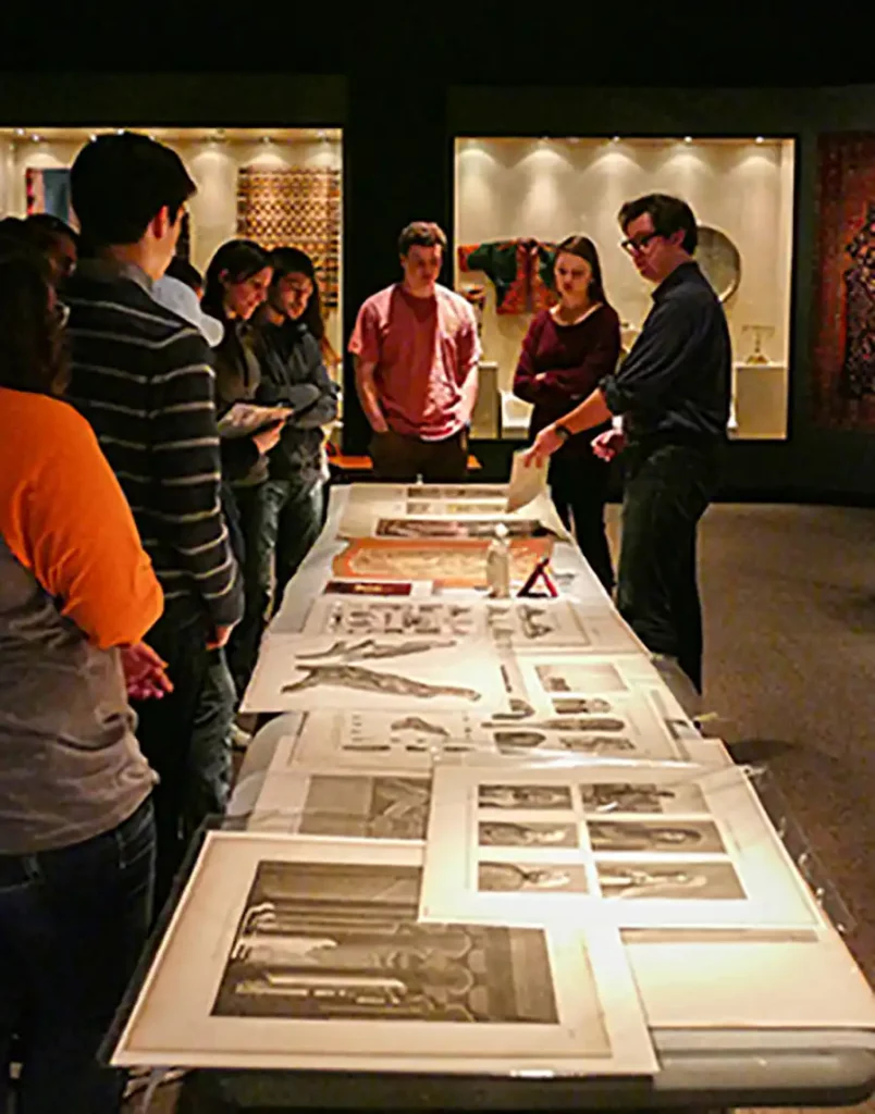 History Students in a museum looking at archive materials.